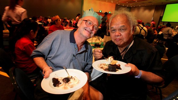 Steven Koop, from Acacia Ridge, and Kenny Lynn, from Woolloongabba, enjoy the pudding served at the annual Salvation Army Christmas lunch at the Brisbane Convention and Exhibition Centre.