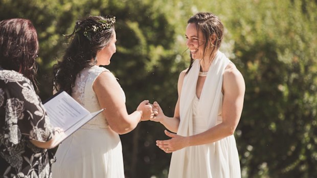 Sally and Kara Bromley seal their marriage with a pinkie promise.