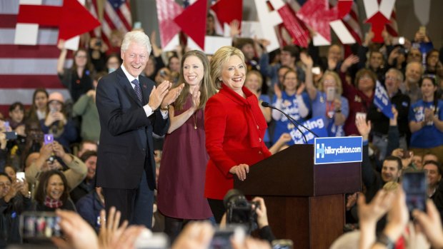 Democratic presidential candidate Hillary Clinton, accompanied by former President Bill Clinton and their daughter Chelsea Clinton, arrives at her caucus night rally at Drake University in Des Moines, Iowa.