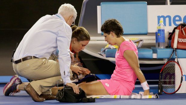 Time out: Carla Suarez Navarro receives medical treatment during her fourth round match.