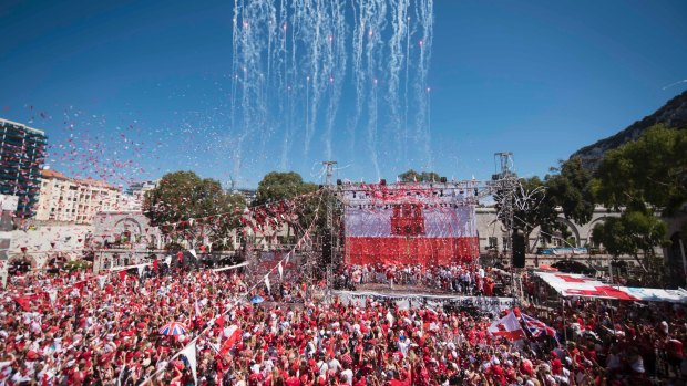 Rockets and streamers are seen during the National Day celebrations at Case Mates square in  Gibraltar.