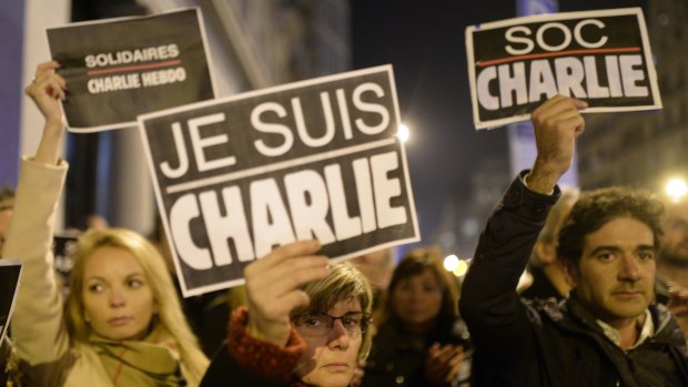 People in Spain join a demonstration to show their solidarity for the slain <i>Charlie Hebdo</i> journalists outside the French Consulate in Barcelona.