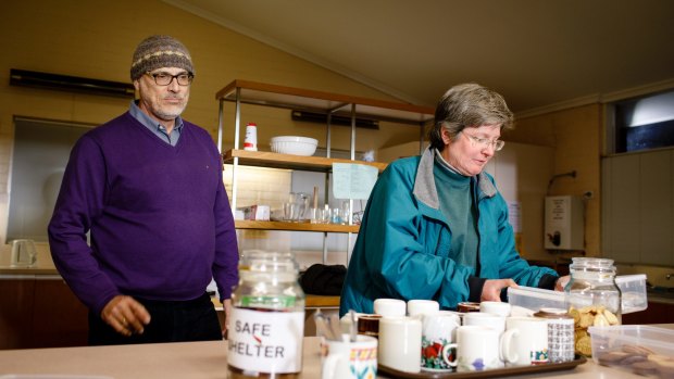 Safe Shelter volunteers Ken Vesperman, left, and Katy Nicholls prepare hot drinks at St Columba's Uniting Church in Braddon for homeless people looking for shelter this week in Canberra.