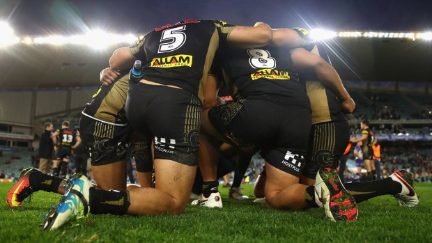 Giving thanks: Panthers players huddle after winning the elimination final against the Bulldogs.