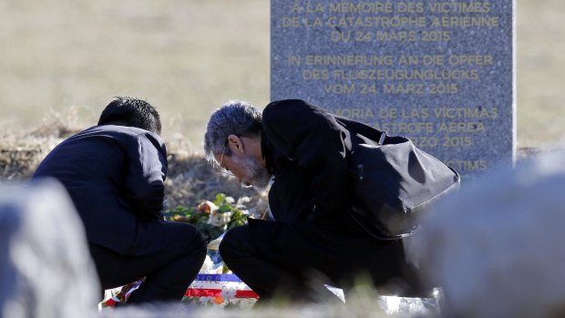 People pay their respects at the memorial for the victims of the air disaster in the village of Le Vernet, near the crash site.