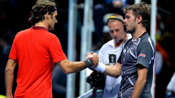 Tense match: Rodger Federer shakes hands with  Stanislas Wawrinka.
