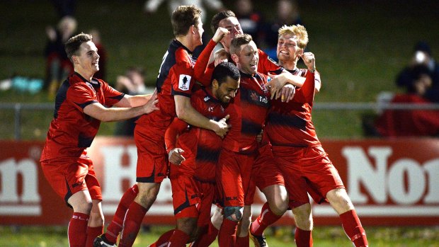 Paul O'Brien is mobbed by Redlands United teammates after his extra-time winner against Adelaide United in the  FFA Cup round of 32.