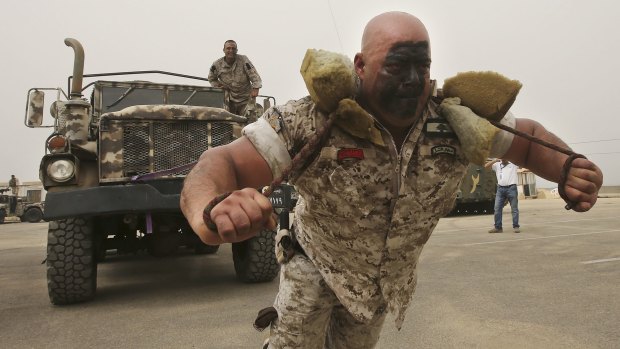 A Lebanese commando pulls an armoured truck at this month's Security Middle East Shows in Beirut.