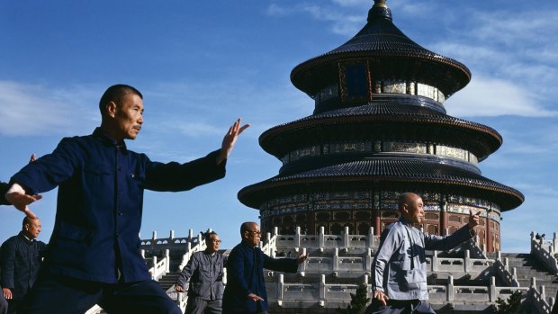 Men practise tai chi in front of the Temple of Heaven in  Beijing, China.