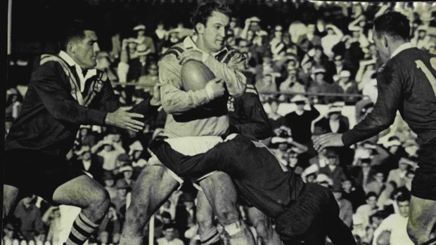 Proud tradition: Johnny Raper is tackled by the Country defence during the 1966 Sydney versus Country match.