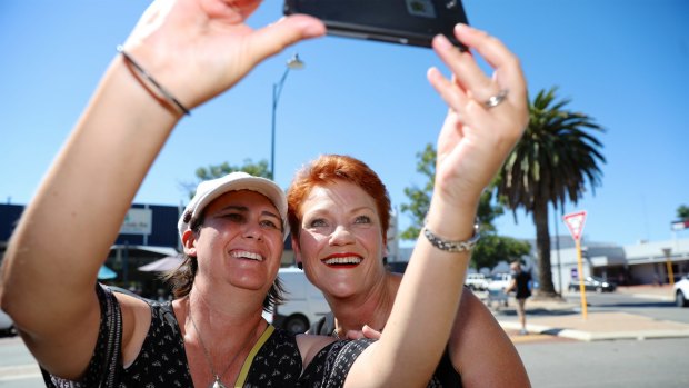 One Nation leader Pauline Hanson has a picture taken with a member of the public while campaigning in Mandurah, south of Perth.
