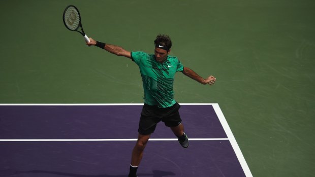 Roger Federer of Switzerland plays a backhand in his match against Rafael Nadal of Spain in the final of the Miami Open.