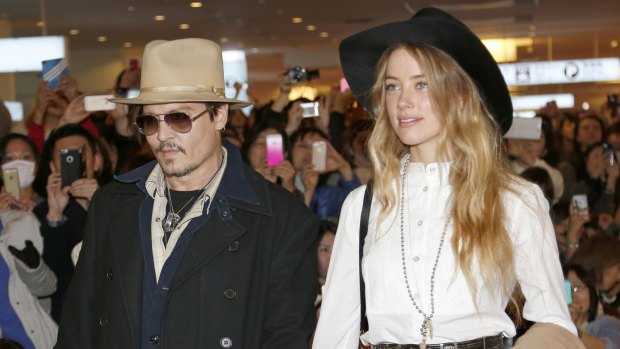 Amber Heard and Johnny Depp, pictured in 2015, will settle their divorce case.