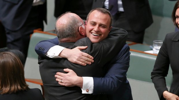 Liberal MP Tim Wilson is embraced by his colleague Warren Entsch after delivering his maiden speech in August.