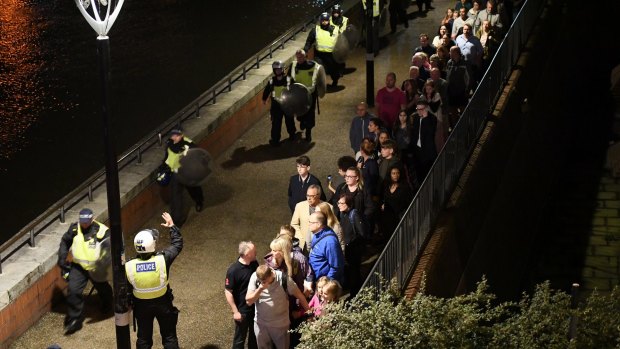 People are lead to safety away from London Bridge.