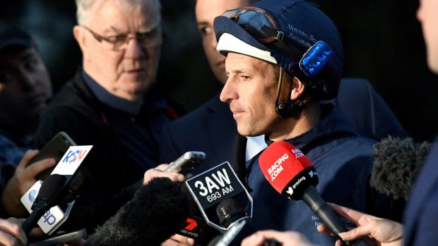 Spotlight: Hugh Bowman speaks to the media after taking Winx for a light gallop at Flemington before her much-anticipated race-day debut at Flemington.