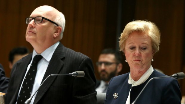 Professor Triggs, pictured with Attorney-General George Brandis, said she often suffered "political and media abuse".