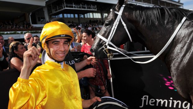 Winning jockey Joao Moreira waves to the crowd after the race.