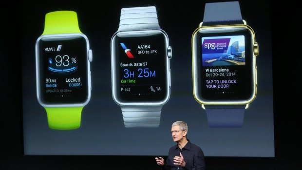 Apple chief Tim Cook stands in front of a screen displaying apps that will be available for the Apple Watch.