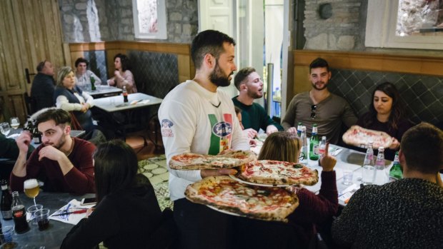 A waiter in Naples serves Sorbillo's pizzas, 'a product that has conquered the world'.