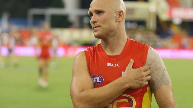 Gary Ablett holds his shoulder after losing the round two AFL match between the Gold Coast Suns and the St Kilda Saints.
