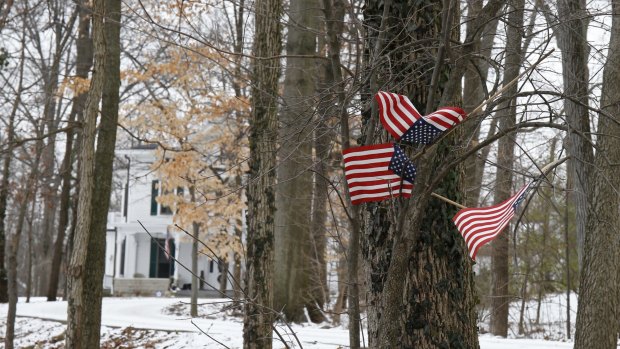 Small American flags fly in front of the Warmbier family home in Wyoming, Ohio, after Otto Warmbier's detention.  