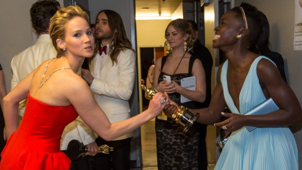 Jennifer Lawrence and Lupita Nyong'o hamming it up for the cameras backstage at the 2014 Oscars.