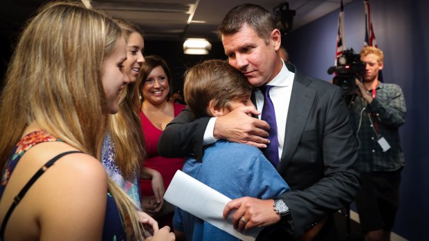 Mike Baird embraces his family after resigning as premier on January 19.