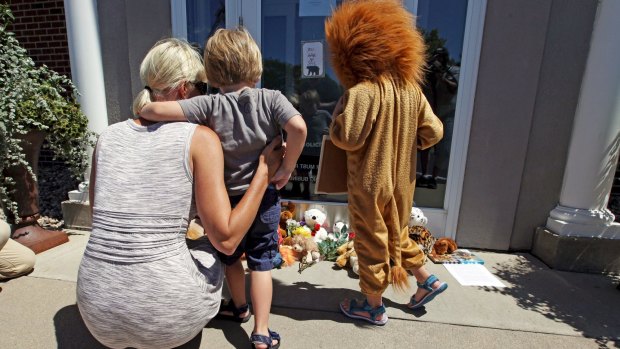 Flowers and stuffed animals have been left outside Walter Palmer's River Bluff Dental practice in Minnesota.