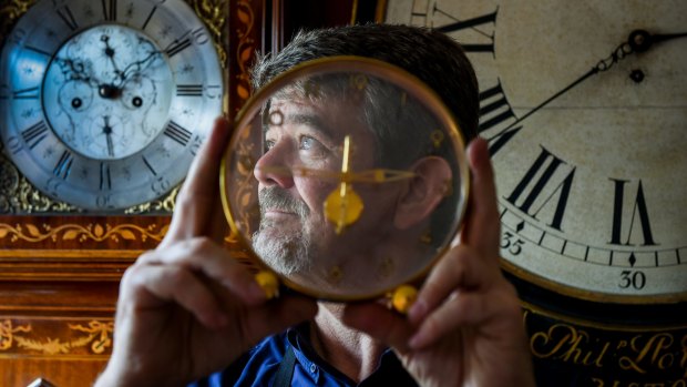 Master clockmaker: Andrew Markerink in his workshop with antique clocks and watches. 