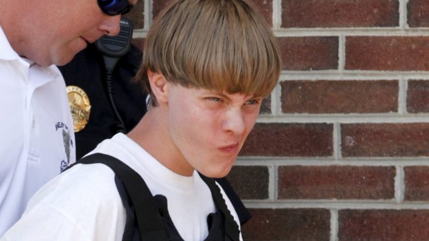 Police lead Dylann Roof, 21, into the courthouse in Shelby, North Carolina, where he was charged with nine counts of murder after a mass shooting at a Charleston church.