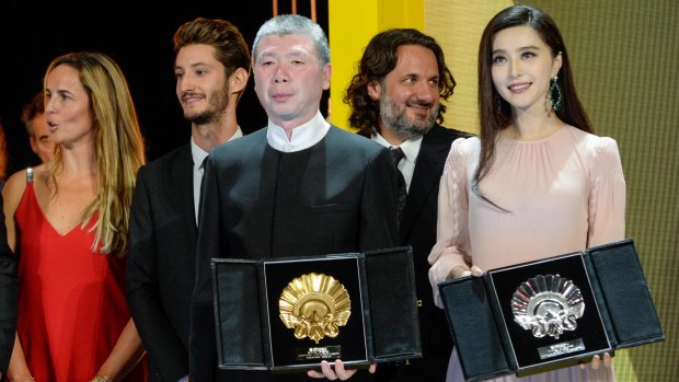 Chinese director Feng Xiaogang (left) wins best film award for <i>I Am Not Madame Bovary</i> and film star Fan Bingbing is awarded the Silver Shell for best actress for the same movie at the 64th San Sebastian Film Festival in Spain.