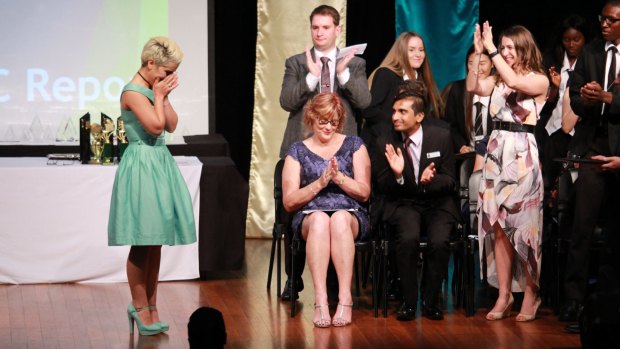 An emotional moment on stage as Mojgan Shamsalipoor graduates at the Yeronga State High School awards night in November 2016.