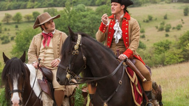 Josh Gad as Le Fou, left, and Luke Evans as Gaston in a scene from <i>Beauty and the Beast</i>.