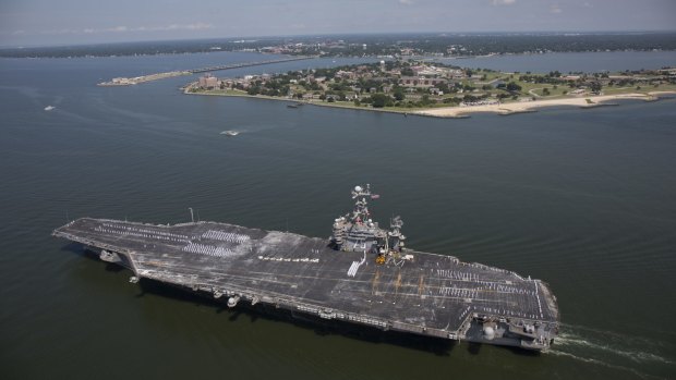 The aircraft carrier USS Harry S. Truman on its way into dock in Norfolk, after an eight-month deployment against IS militants in Iraq and Syria.