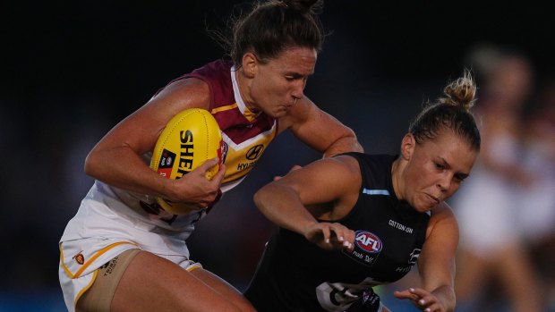Brisbane's Emily Bates and Carlton's Maddison Gay tussle for the ball.