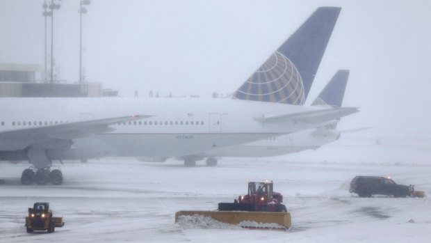 Snowplows work to keep the grounds clear at Newark Liberty International Airport in Newark, N.J.