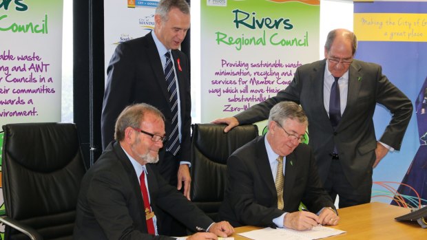 Local Government Minister Tony Simpson and Rivers Regional Council chief executive Alex Sheridan witness Gosnells Mayor Dave Griffiths and RRC chairman Ron Hoffman sign the contract what will end eight councils' dependence on landfill. 