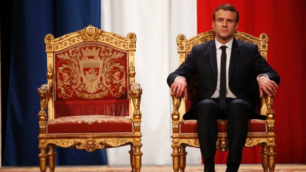 French President Emmanuel Macron listens as Paris Mayor Anne Hidalgo delivers her speech during a ceremony at the Hotel de Ville in Paris, on Sunday.
