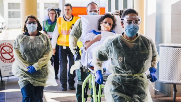 A patient arrives at Canberra Hospital by ambulance from Calvary as part of an Ebola training exercise.