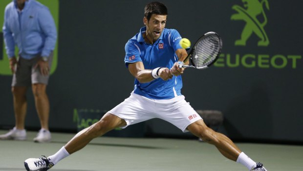 Novak Djokovic returns service to Tomas Berdych.