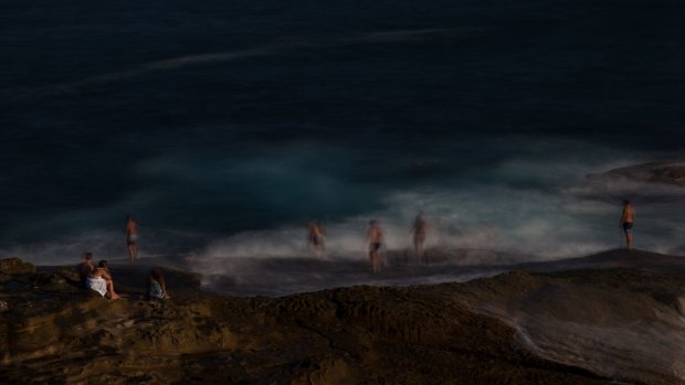 Swimmers cool off in the large swell off the rock ledge at the north end of Maroubra.