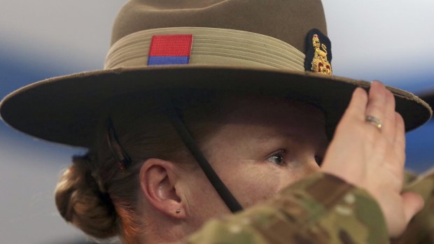 Pull back: A soldier for the International Security Assistance Force (ISAF) salutes during a ceremony at the ISAF headquarters in Kabul.