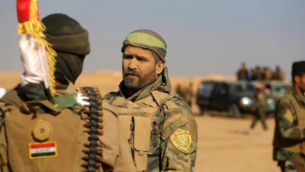 Fighters of the Popular Mobilisation Forces stand at the front line outside Mosul in November.