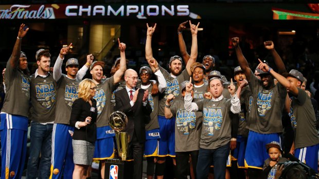 Deserved champions: The Golden State Warriors celebrate with the Larry O'Brien NBA Championship Trophy.