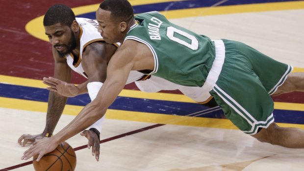 Loose ball: Cleveland Cavaliers guard Kyrie Irving and Boston Celtics opponent Avery Bradley dive for possession. 