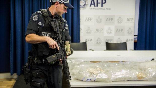 An armed police officer stands guard over one of the ACT's largest drug seizures of methamphetamine.