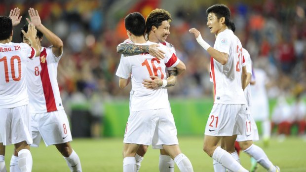 China's Sun Ke celebrates his goal with teammates.