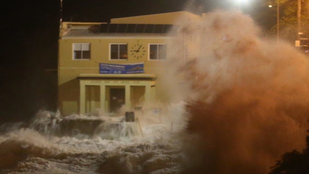 The storm sends waves crashing on the Coogee Surf Life Saving Club.