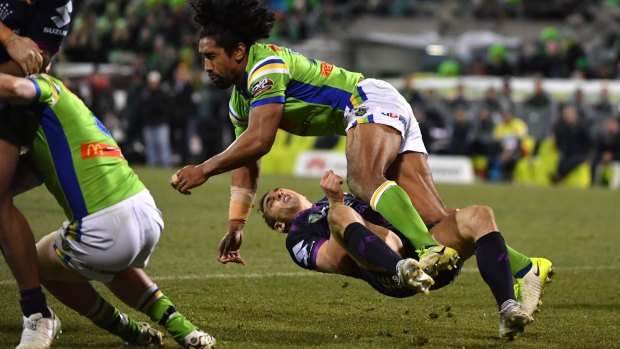 Billy Slater goes to ground after being collected high by Sia Soliola.